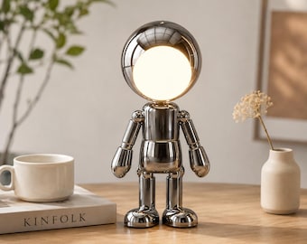 Lampada da comodino a forma di robot spaziale, moderna luce notturna a tema astronauta, illuminazione ambientale artistica, arredamento minimalista per la camera da letto, lampada da tavolo futuristica,