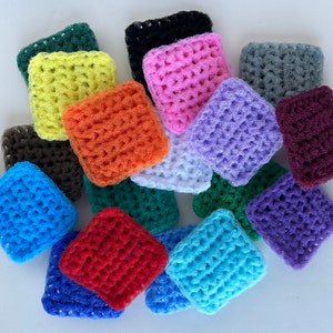 May include: A collection of 15 colorful crocheted dishcloths in various colors, including blue, green, red, orange, purple, pink, white, gray, and black.