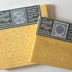 May include: Two "Quilt Magic" no-sew wall hanging kits. The kits feature a yellow foamboard with a geometric design and a black label with the product name and a sample quilt image. The labels also state the kits are fun and easy to make.