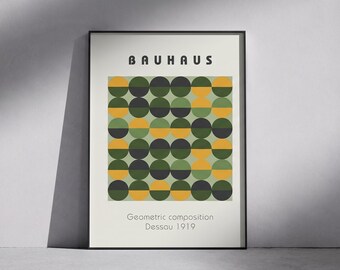 May include: A framed rectangular wall art print featuring the text BAUHAUS at the top and Geometric composition Dessau 1919 at the bottom. The center displays a grid of circles in shades of dark gray, mustard yellow, and olive green.