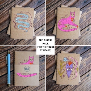 May include: A collection of four kraft paper greeting cards with whimsical illustrations. The cards feature a pink cat, a blue snake, and other unique designs. The text "THE QUIRKY PACK (FOR THE YOUNG AT HEART)" is displayed in a white box.
