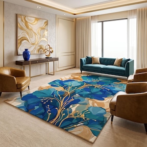 May include: A rectangular area rug featuring a large-scale floral pattern in shades of deep blue, teal, and light blue with gold-toned stems and leaf accents. The design is set against a neutral beige background, covering the floor of a living room.