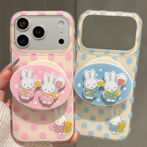 May include: Two clear phone cases with a polka dot pattern and cartoon bunny designs. One case has pink polka dots and a pink bunny design, the other has blue polka dots and a blue bunny design. The text "Super Cute Case" is at the bottom.