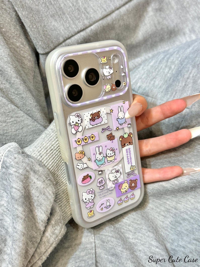 May include: A clear phone case with a purple border and a variety of cartoon character stickers. The stickers include Hello Kitty, bears, bunnies, and other cute designs. The case has a camera cutout and the text "Super Cute Case".