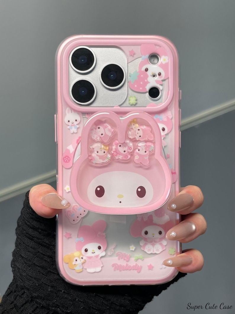 May include: Pink phone case featuring a My Melody design. The case has a clear border and includes a 3D My Melody character and other decorative elements. The text "Super Cute Case" is visible at the bottom right.