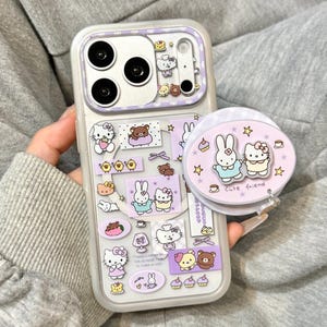 Funda MagSafe morada de Hello Kitty y conejito para iPhone con soporte vibrador, compatible con iPhone 17, iPhone 17 Pro y iPhone 17 Pro Max.