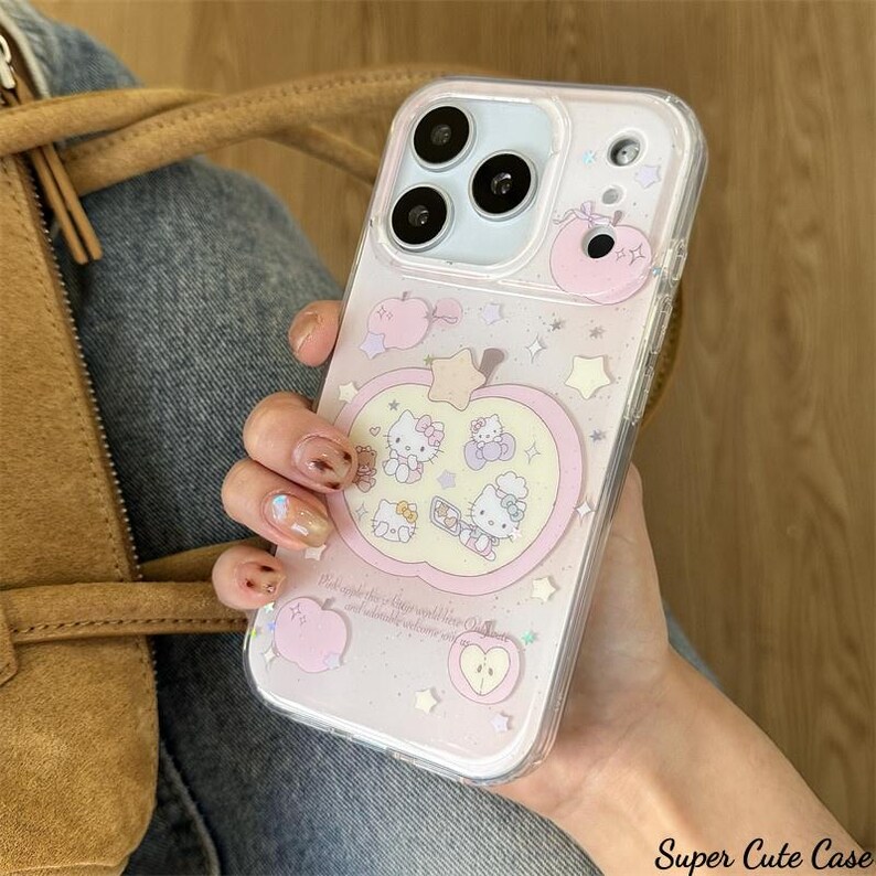 May include: Clear iPhone case with a pink apple design and Hello Kitty characters. The case has a glittery background with star and apple accents. The text "Super Cute Case" is visible on the bottom right.