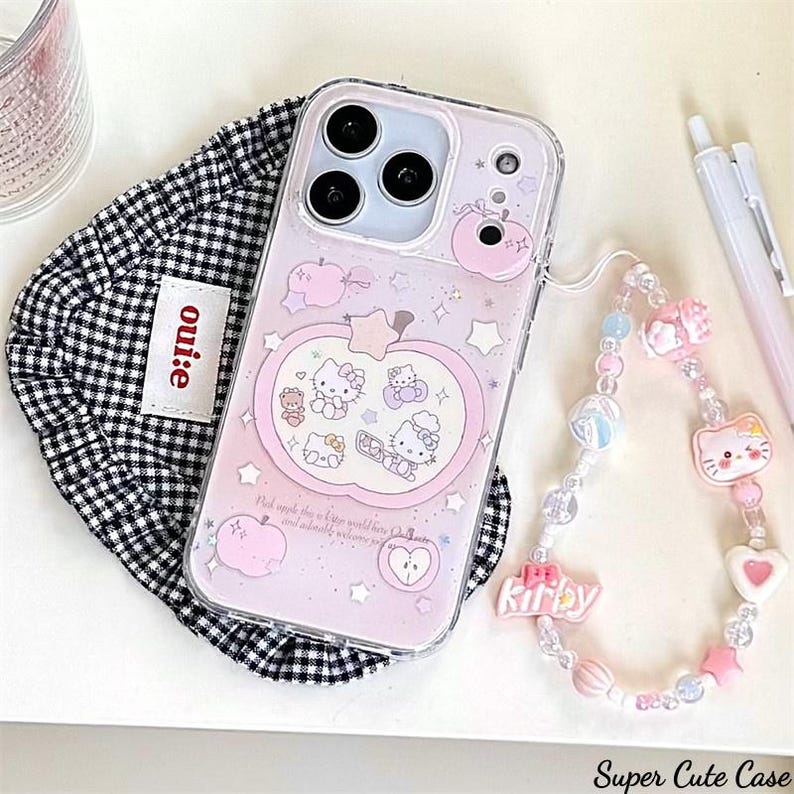 May include: A pink phone case with a Hello Kitty design, featuring an apple shape and various Hello Kitty characters. The case has a clear strap with beads and charms. The text "Super Cute Case" is visible.