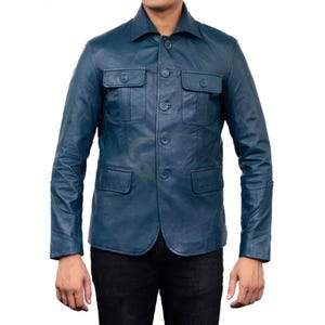 May include: A blue leather jacket with a button-up front, two chest pockets, and two lower pockets. The jacket has a collared neckline and long sleeves. The leather appears to have a slight sheen.