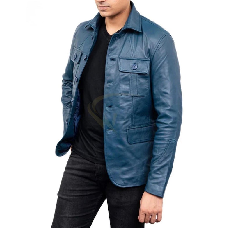 May include: A blue leather jacket with a button-up front, two chest pockets, and a collared neckline. The jacket is worn over a black shirt and paired with black jeans. The jacket's color is a deep, rich blue.