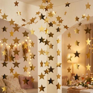 May include: A decorative hanging garland consisting of multiple vertical strings featuring numerous metallic gold stars. The stars are uniform in shape and size, suspended at regular intervals along thin, clear threads to create a cascading effect.