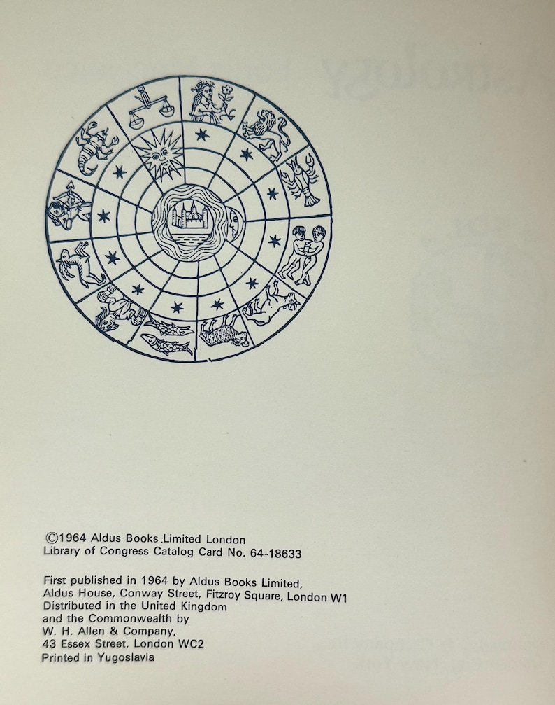 May include: A vintage book page featuring a detailed illustration of a zodiac wheel in blue ink. The wheel is divided into segments, each depicting a zodiac sign. Text at the bottom includes the publisher's information and copyright details.