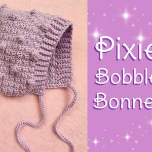 May include: A purple crocheted pixie bonnet with a bobble stitch pattern and ties. The bonnet has the text "Pixie Bobble Bonnet" on a pink background with white stars.