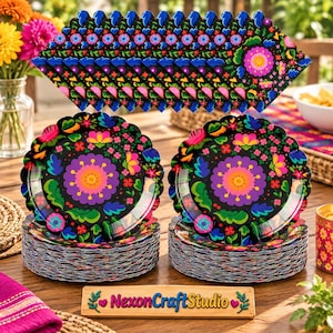 May include: Two stacks of round paper plates featuring a black background with a vibrant floral pattern in pink, purple, orange, green, and blue. The plates have scalloped edges. A wooden sign in front displays the text NexonCraftStudio.