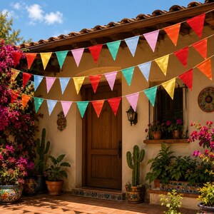 May include: Three rows of triangular bunting flags in vibrant colors including red, orange, yellow, light blue, pink, and green, strung across the front of a stucco building with a wooden door, potted cacti, and blooming bougainvillea plants.