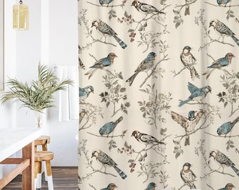 May include: A beige shower curtain with a repeating pattern of birds on branches. The birds are in shades of blue, brown, and grey, with the branches and leaves in muted tones. The curtain is designed for a bathroom.