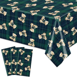 May include: A green and navy plaid tablecloth with a repeating pattern of teddy bears wearing blue and green bow ties. Four matching placemats are in the foreground.
