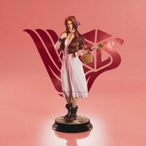 May include: A detailed figurine of a character from Final Fantasy VII, Aerith Gainsborough, stands on a circular base. She wears a white dress, brown jacket, and boots, holding a basket and flowers. The background is a solid pink with a stylized logo.