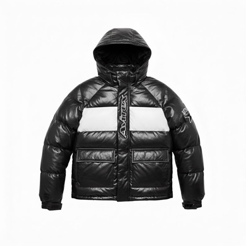 May include: Black puffer jacket with a hood, white stripe across the chest, and two front pockets. The jacket features the brand name "Avirex" in white lettering down the centre and a star logo on the sleeve.