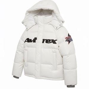 May include: A white puffer jacket with a hood. The jacket features the brand name "Avi rex" in black block letters across the chest and a star logo on the sleeve. The cuffs have black and white stripes.
