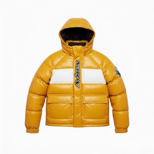May include: Mustard yellow puffer jacket with a hood and two front pockets. The jacket features a white stripe across the chest with the brand name "Avirex" in black. The jacket has a black interior lining and a small logo on the sleeve.