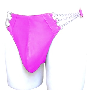 May include: Bright pink leather underwear with silver chain accents. The underwear has a unique design with a high waist and a low-cut front. The silver chains are attached to the sides and back of the underwear.