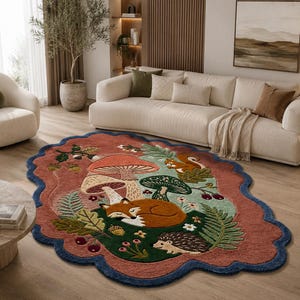 May include: An oval-shaped area rug with a scalloped edge featuring a forest scene. The design includes a sleeping fox, a hedgehog, a squirrel, mushrooms, acorns, and ferns in shades of terracotta, dark green, light green, and brown.