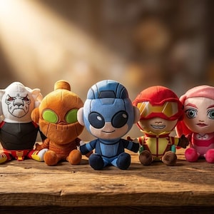 May include: Five plush superhero dolls in various colors sit on a wooden surface. The dolls include a white-faced character, an orange character with green eyes, a blue character, a red character, and a pink character.