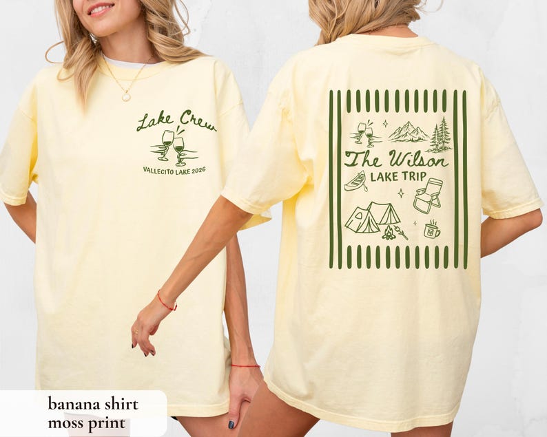May include: A light yellow t-shirt with the text "Lake Crew" and "Vallecito Lake 2026" printed on the front. The back of the shirt features a green graphic with the text "The Wilson Lake Trip" and camping-themed illustrations.