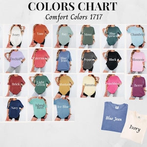May include: A color chart of Comfort Colors 1717 t-shirts. The chart displays various shirt colors, including white, ivory, yam, bay, moss, blue spruce, chambray, espresso, orchid, watermelon, blue jean, pepper, black, blossom, crimson, brick, light green, mustard, banana, crunchberry, berry, denim, navy, island reef, and ice blue.