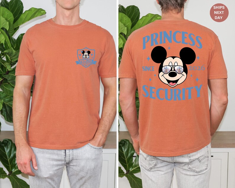 May include: Burnt orange t-shirt with a Mickey Mouse graphic on the front and back. The front features a small Mickey Mouse emblem. The back displays Mickey wearing sunglasses with the text "PRINCESS SECURITY SINCE 2020".