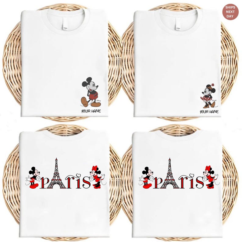 May include: White t-shirts featuring Mickey Mouse and Minnie Mouse designs. Some shirts have the Eiffel Tower with the word "Paris". Each shirt has the option to add a name. The shirts are displayed on a woven background.
