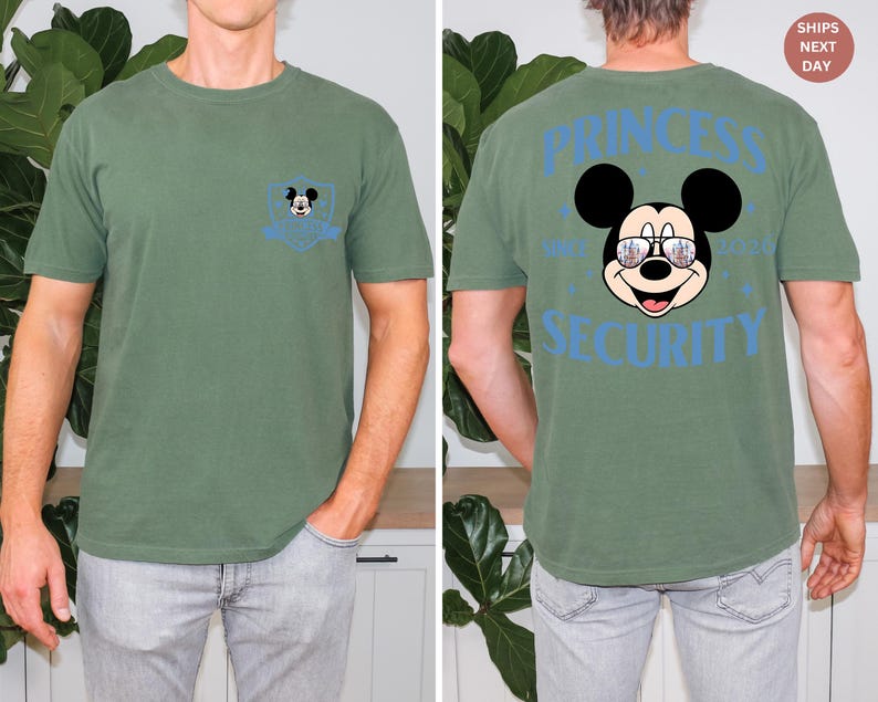 May include: Green t-shirt with a Mickey Mouse graphic on the front pocket and back. The back of the shirt features Mickey Mouse wearing sunglasses with the words "PRINCESS SECURITY".