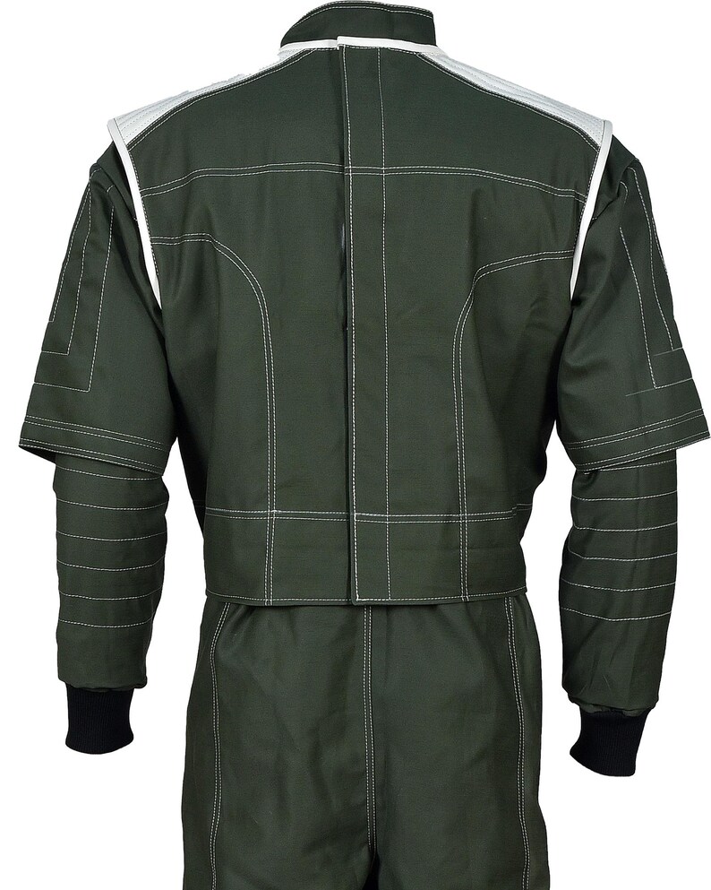 May include: A dark olive green racing suit featuring white contrast stitching throughout. The jacket portion has white shoulder panels, a high collar, and black ribbed cuffs at the wrists. The design includes horizontal quilted detailing on the sleeves.