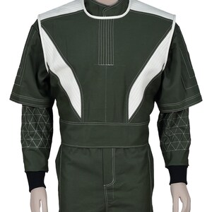 May include: A dark olive green jumpsuit featuring a high collar and white quilted panels on the shoulders and chest. The sleeves have a geometric triangular stitched pattern on the forearms, finished with black ribbed cuffs and white contrast stitching.