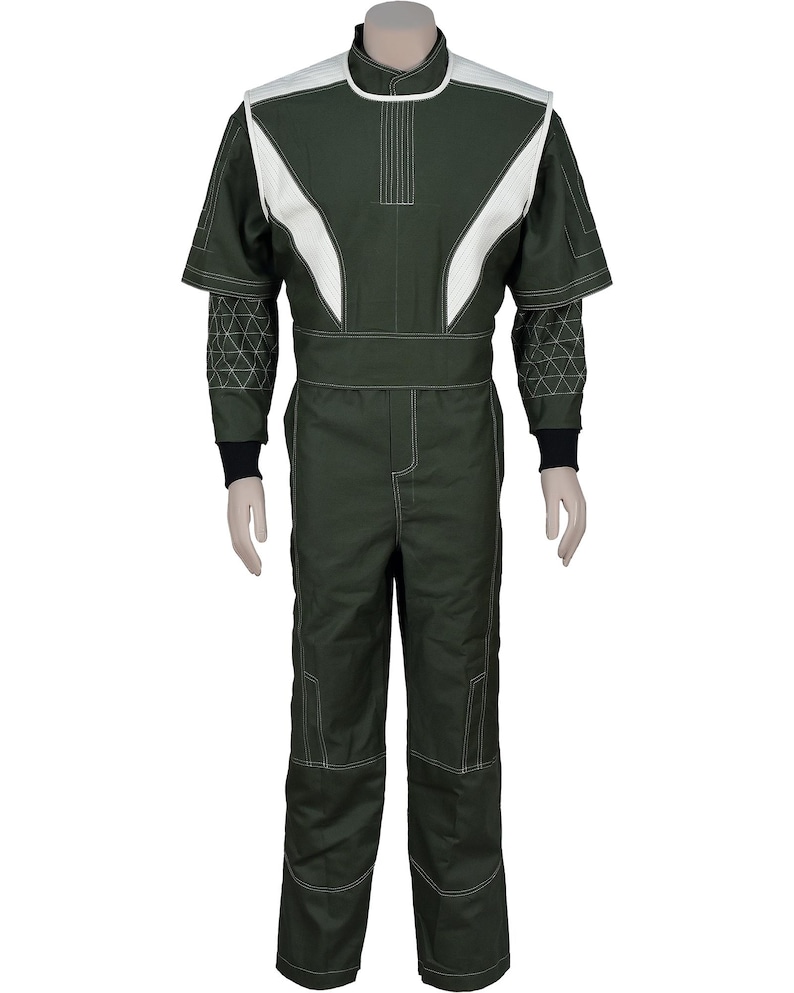 May include: A dark olive green jumpsuit featuring white shoulder panels and white piping details. The garment includes short sleeves with black cuffs, a high collar, and a geometric triangular pattern stitched onto the lower sleeves and legs.