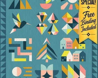 May include: A teal quilt featuring a grid of geometric patterns including triangles, a hummingbird, diamonds, houses, and abstract shapes. A yellow vertical banner on the right side displays the text SHOP SPECIAL! Free Binding Included.
