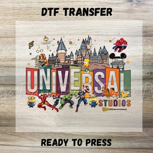 May include: A DTF transfer sheet featuring the text UNIVERSAL STUDIOS in colorful block letters. The design includes illustrations of a castle, Spider-Man, Bart Simpson, Iron Man, Hulk, Captain America, Minions, and various magical themed icons.