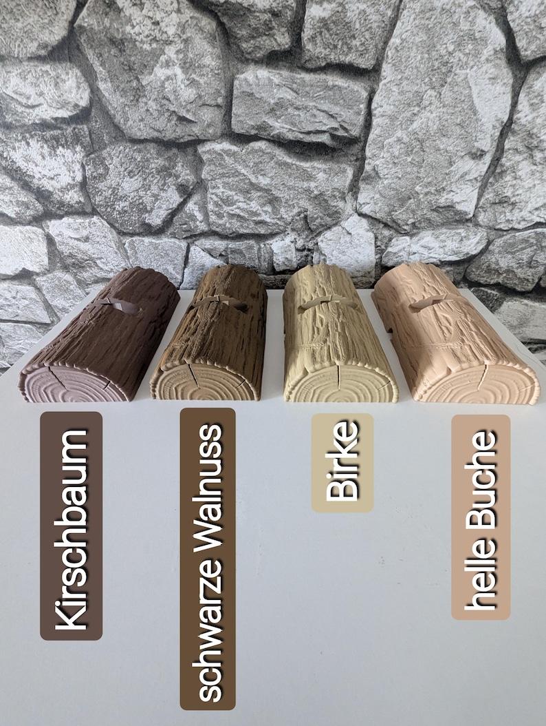 May include: Four semi-cylindrical log-shaped objects with textured bark surfaces, arranged in a row. Each piece features a small rectangular cutout on top. The colors range from dark brown to light beige, labeled Kirschbaum, schwarze Walnuss, Birke, and helle Buche.