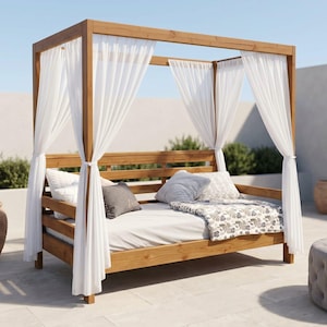 May include: A wooden canopy daybed with white curtains, pillows, and a patterned blanket. The bed frame is made of light brown wood. Decorative pots and a gray ottoman are nearby.