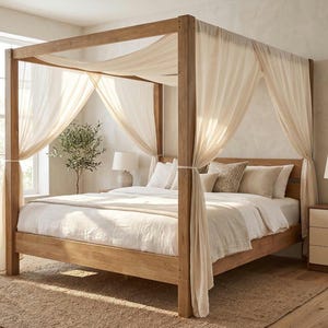 May include: A four-poster bed frame crafted from light brown wood, featuring tall vertical posts and a horizontal canopy frame. Sheer, off-white fabric drapes elegantly from the top rails, tied back at each corner to reveal the bed with white bedding.
