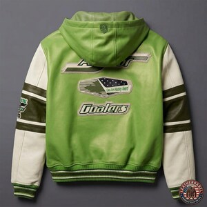 May include: Green leather jacket with a hood and white sleeves. The back features the text "Coolers" and "Can-Am Hockey Award". The jacket has a green and white striped trim at the cuffs and waist. A shield logo is on the hood.