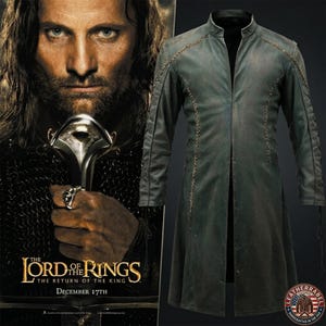May include: A long, dark grey coat with a mandarin collar and decorative braided stitching along the shoulders and sleeves. The coat features a clean, open front design with long sleeves and a structured fit, presented alongside a movie poster.