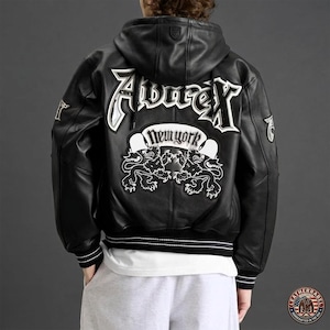 May include: A black leather hooded jacket featuring white embroidered text that reads Avirex and New York, accompanied by two lion graphics on the back. The jacket includes ribbed cuffs and a hem with white stripes, and a small logo on the hood.