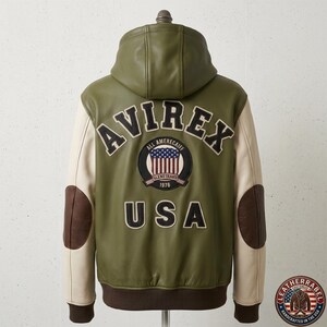 May include: An olive green hooded jacket with cream-colored sleeves and dark brown elbow patches. The back features the text AVIREX in black, a circular patch with a US flag design and the text ALL AMERECAIFF GLENETRANS 1976, and the text USA below.