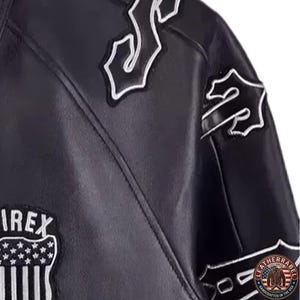 May include: Black leather jacket with white embroidered patches. The jacket features the word "IREX" on a patch with a star and stripe design. Additional patches with stylized lettering are also visible.