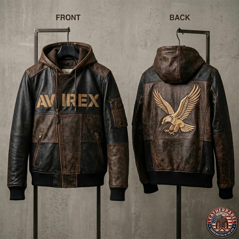May include: A brown and black leather jacket with a hood, shown from the front and back. The front has the text "AVIREX" in gold. The back features a gold eagle emblem. The jacket has a zip closure and several pockets.