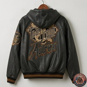 May include: A black leather hooded jacket featuring a large embroidered graphic on the back with the text Twin Dragon and Avirex in gold and black. The jacket has long sleeves with ribbed cuffs and a hem featuring brown and black stripes.