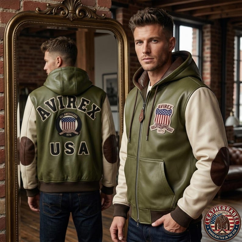 May include: An olive green leather hooded jacket with cream-colored sleeves and brown elbow patches. The back features the text AVIREX and USA with a circular American flag patch. The front chest displays a shield-shaped patch with an American flag.