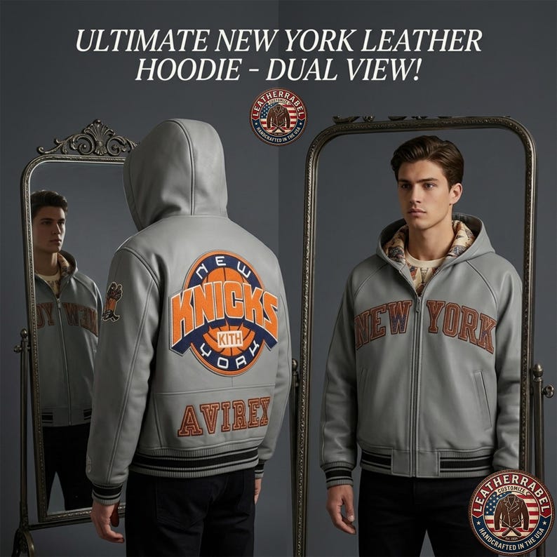 Puede incluir: Una sudadera con capucha de cuero gris claro con el texto ULTIMATE NEW YORK LEATHER HOODIE - DUAL VIEW! La parte trasera muestra un gran logotipo circular naranja y azul de los New York Knicks con la palabra AVIREX debajo. El frente muestra NEW YORK.